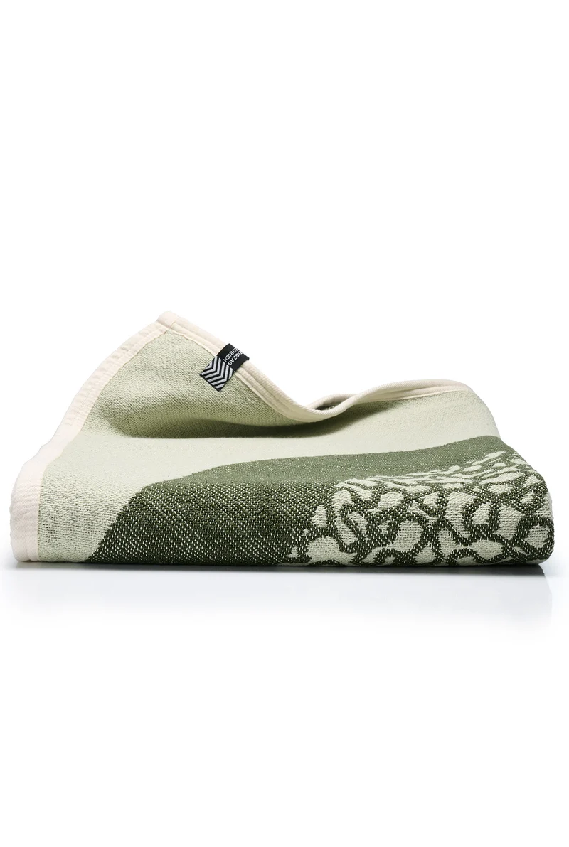 Cotton Blanket “Merging Islands” in Tea Green by Roland Schär