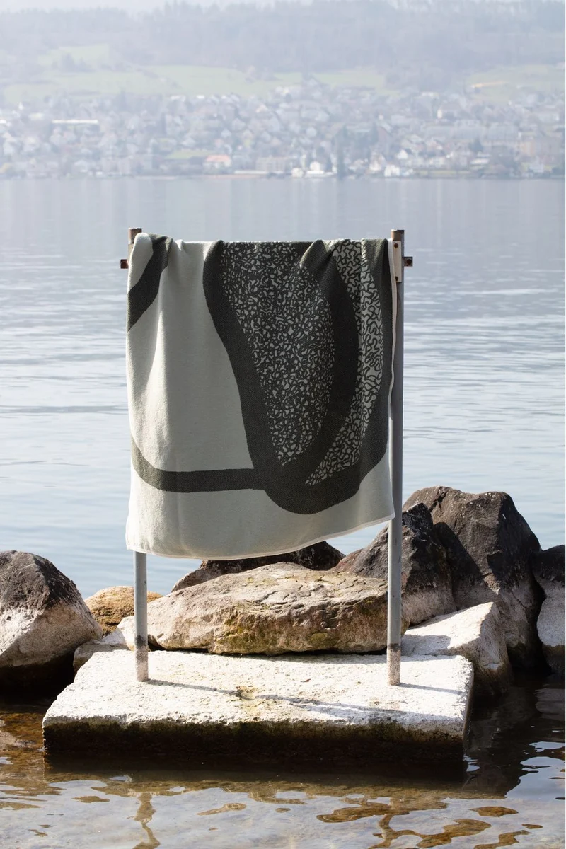 Cotton Blanket “Merging Islands” in Tea Green by Roland Schär